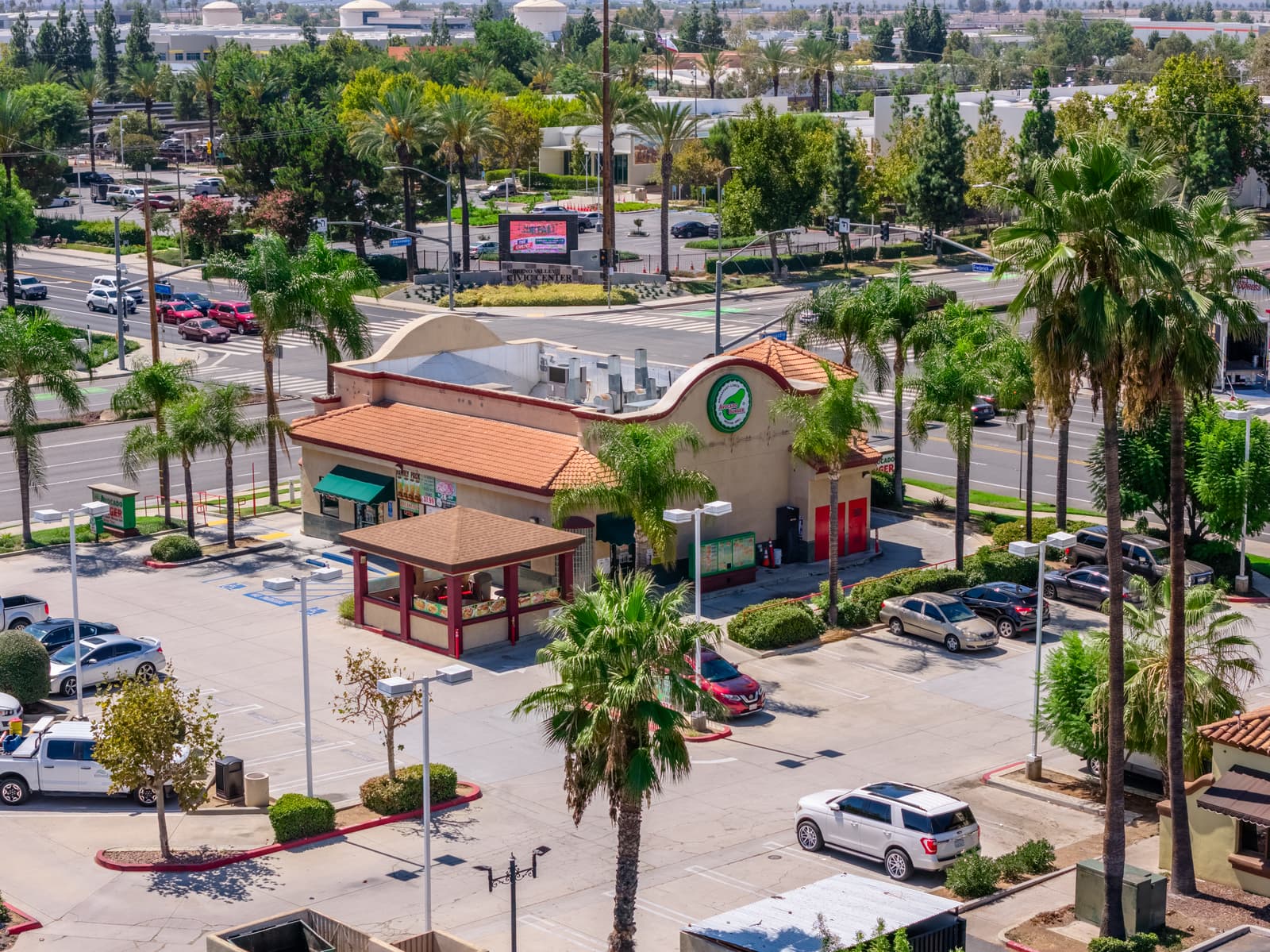 Avocado Burger drive-thru pad at Plaza Del Sol, with the Moreno Valley Civic Center across Frederick Street