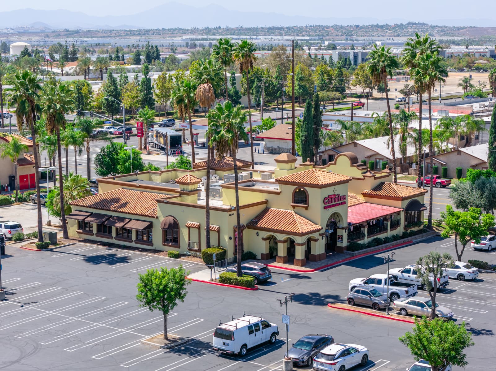Carnitas restaurant pad at 23040 Alessandro Boulevard, with its tile roofs, covered patio, and the parking lot in front