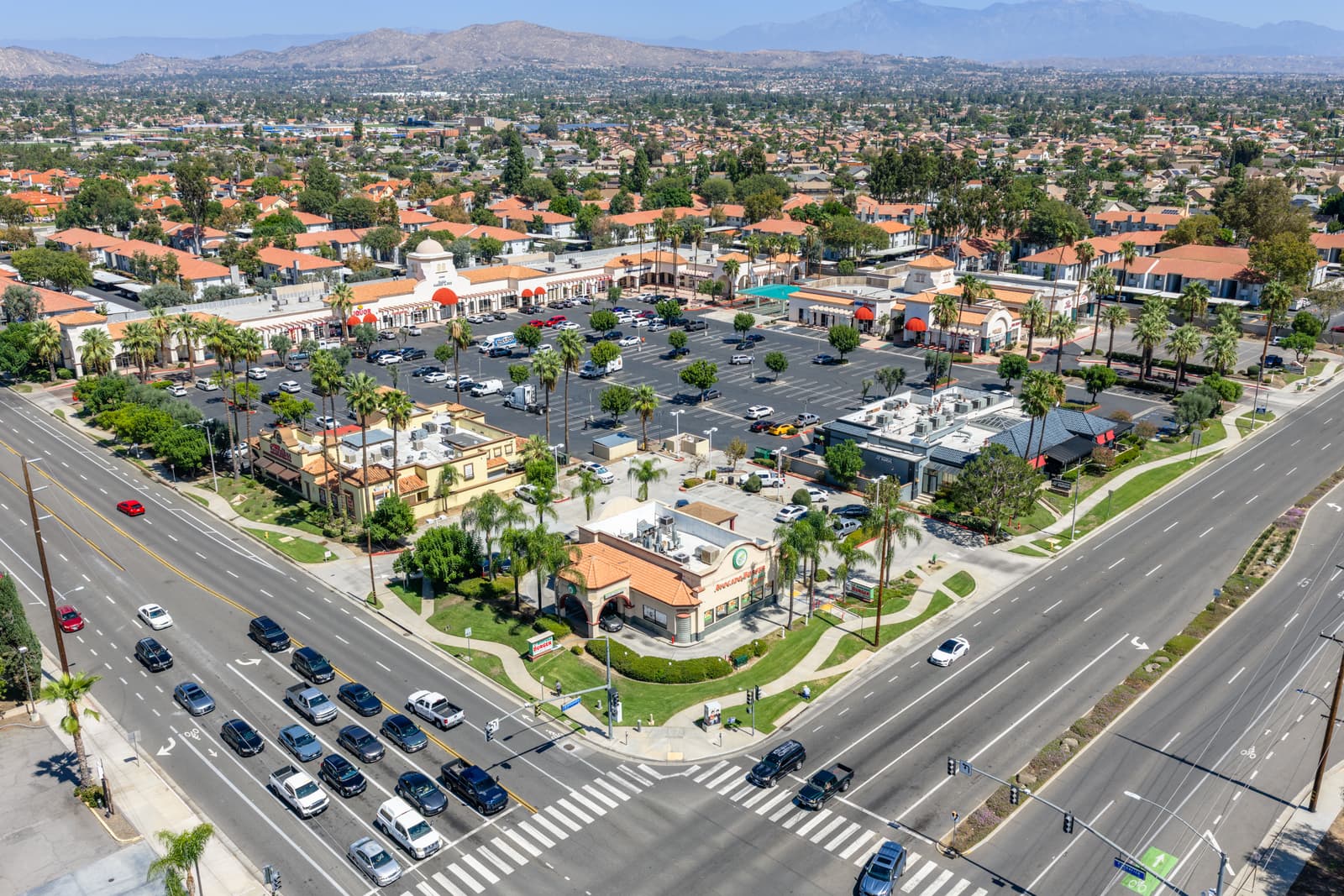 High aerial of Plaza Del Sol from the Alessandro Boulevard intersection with the mountains on the horizon