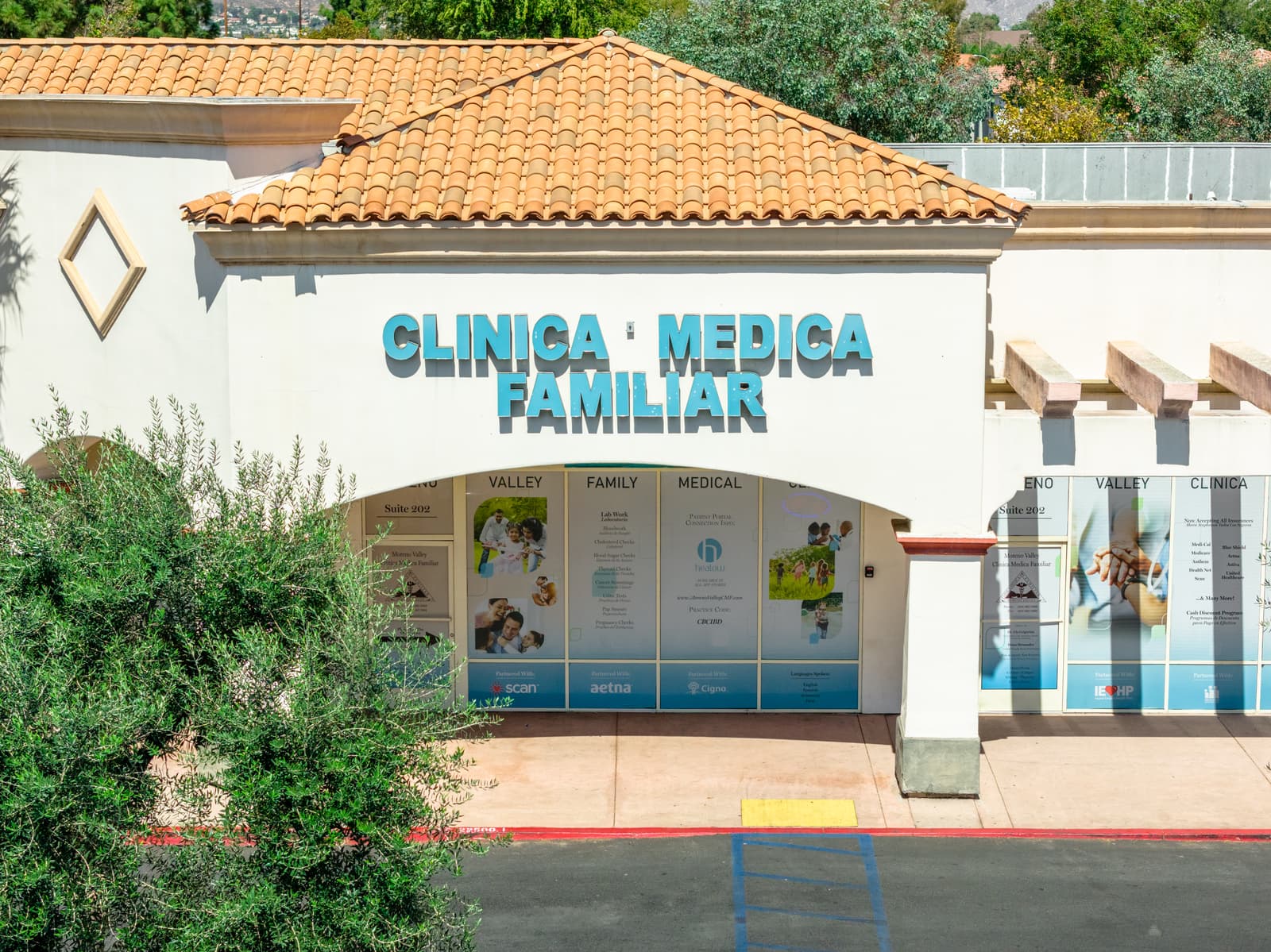 Clinica Medica Familiar storefront at Plaza Del Sol with its tile-roofed entry