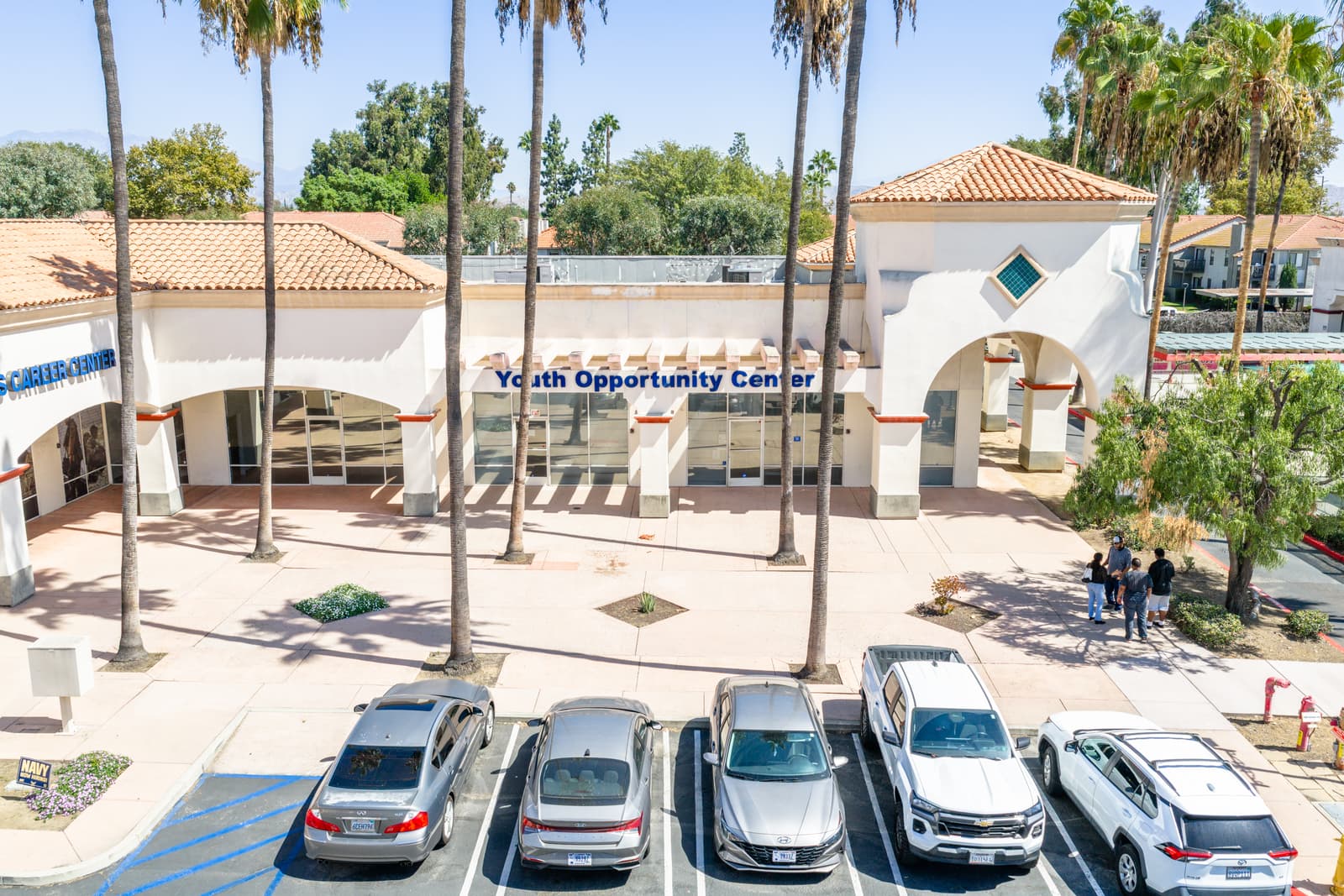 Youth Opportunity Center storefront at Plaza Del Sol with parking in front